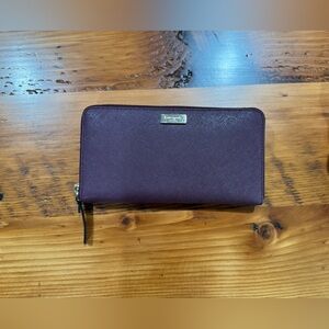 Plum Kate Spade Laurel Way accordion wallet